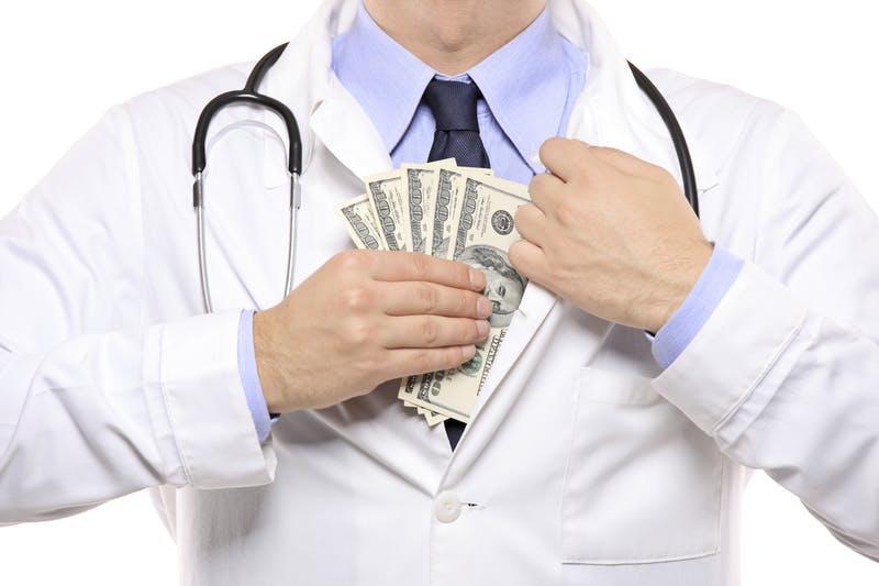 Doctor guardando billetes