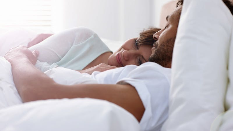 Relaxed couple in bed