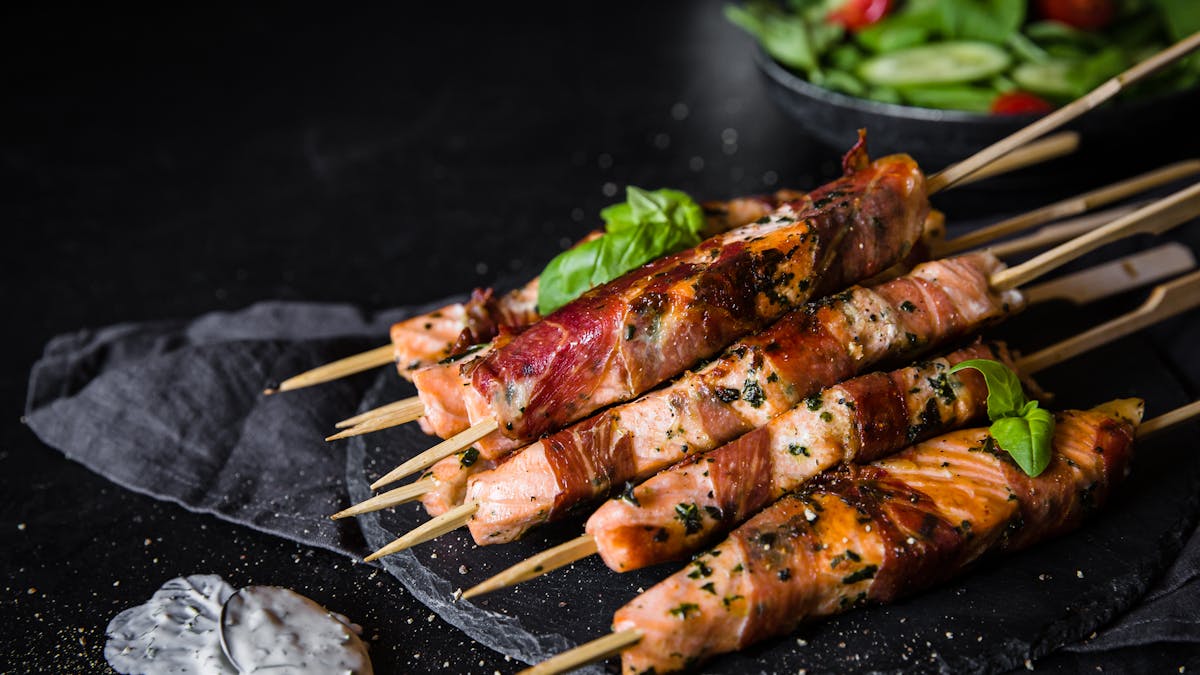 Brochetas de salmón envueltas en prosciutto