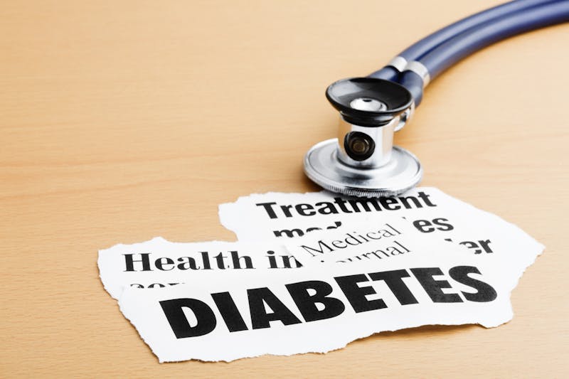 Diabetes headlines with stethoscope on desk