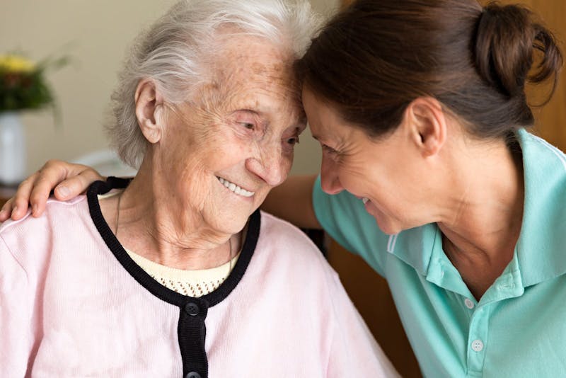 Dementia and Occupational Therapy - Home caregiver and senior adult woman