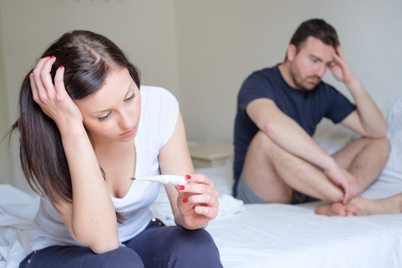 Sad lovers couple after pregnancy test result