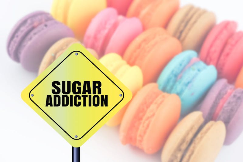 word sugar addiction blurred colorful sweet macaron