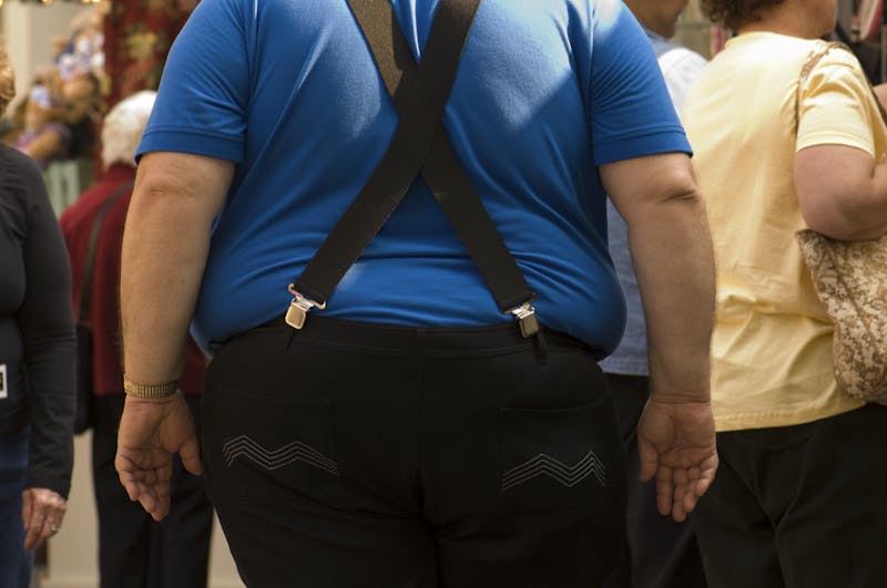 Obese Male with Blue Shirt Black Pants Suspenders Backside