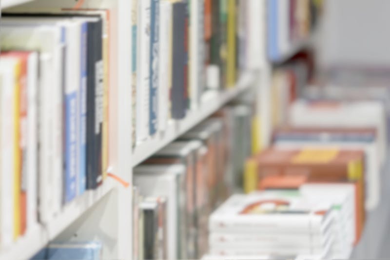 Abstract blurred books, manuals and textbooks, bookshelves with books, library or book store, for light backdrop. Concept for education