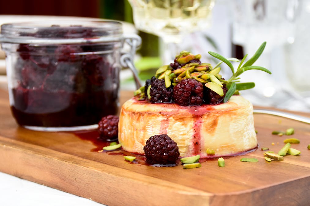 Ugnsgratinerad getost med björnbär och rostade pistagenötter