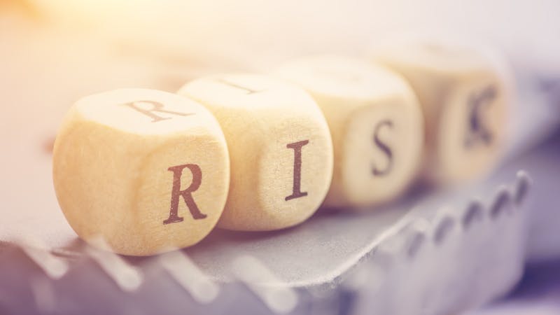 Four dices are arranged in a word "RISK" on a rat trap. Risk involves the chance an investment's actual return will differ from expected return, includes possibility of losing of original investment.