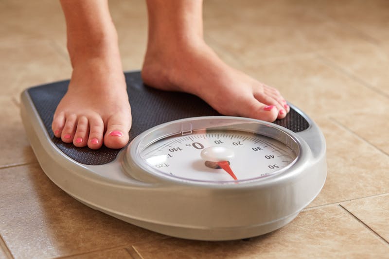Female feet on weight scale