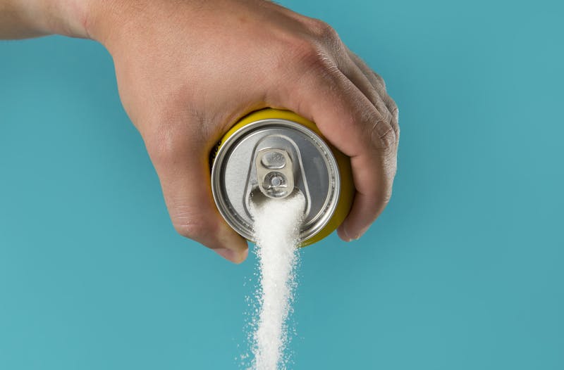 man hand holding lemon refresh drink can pouring sugar stream in sweet and calories content of soda and energy drinks