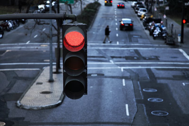 Red light hanging above a paved street in the city