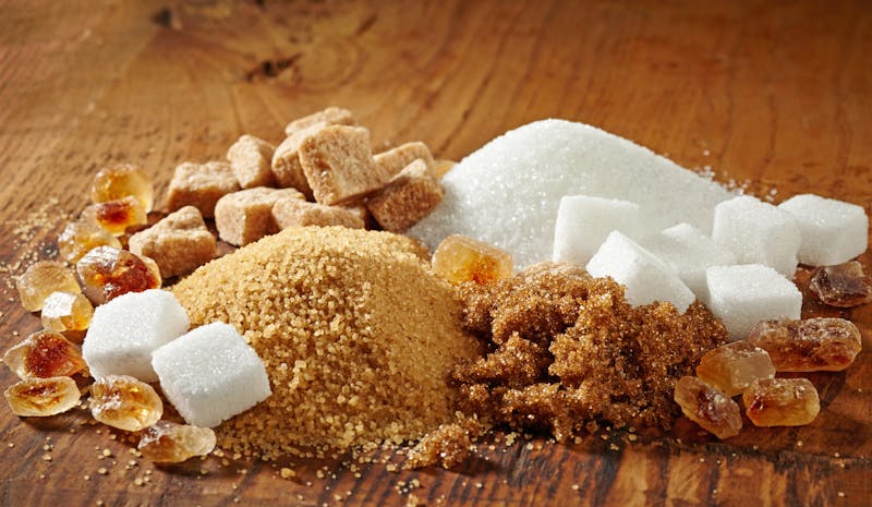 various types of sugar on wooden table