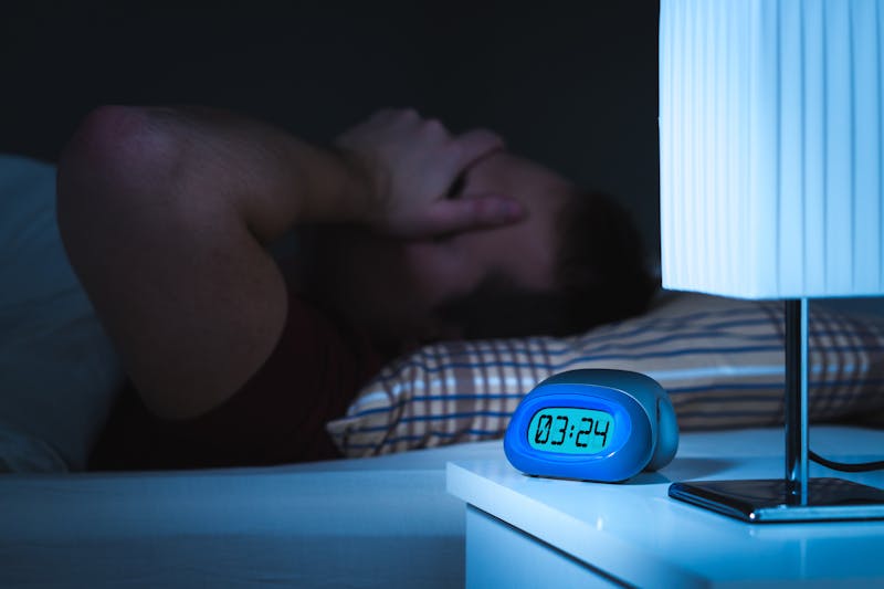 Insomnia and sleepless concept. Man unable to sleep. Exhausted and tired.