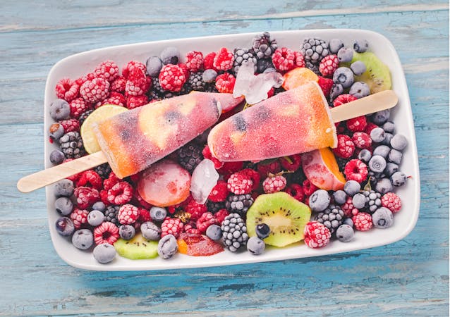 Ice pops on frozen berries