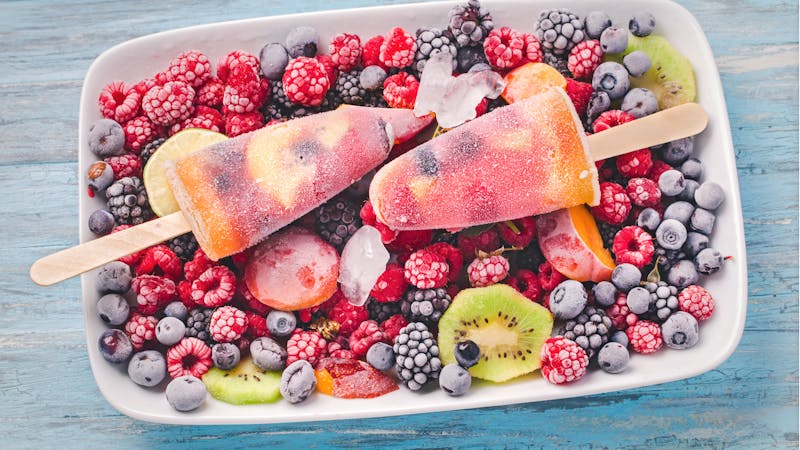 Ice pops on frozen berries