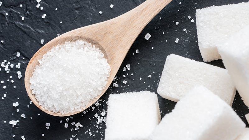 background of white sugar on black