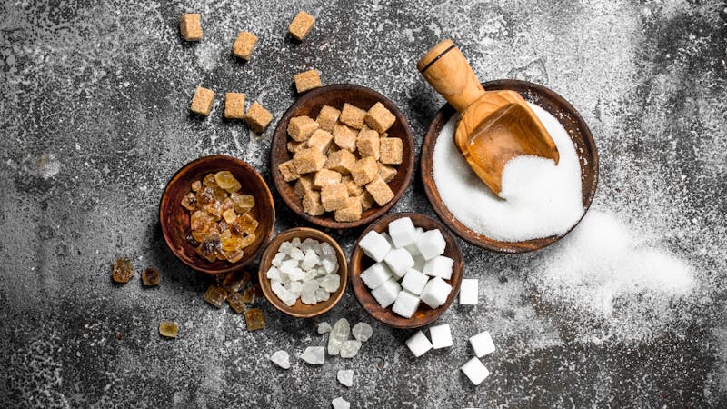 Different kinds of sugar in bowls.