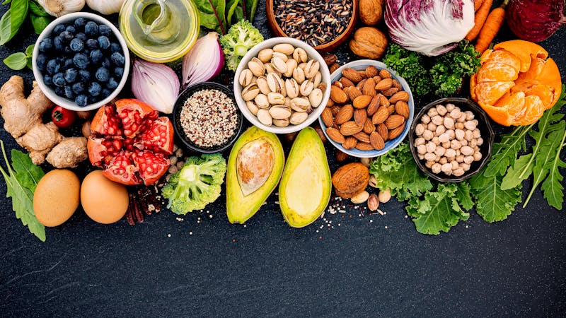 Ingredients for the healthy foods selection. The concept of healthy food set up on dark stone background.