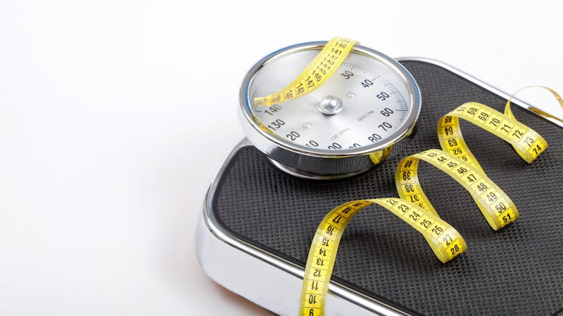 Slim concept with scale and measuring tape on white background top view