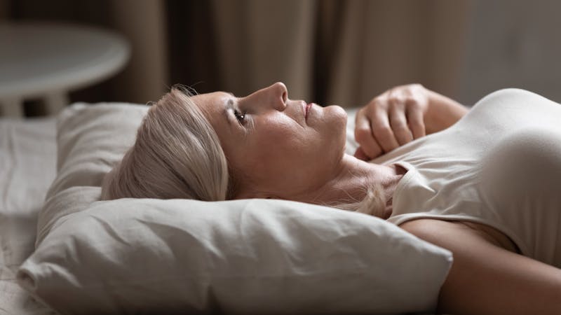 Sleepless mature woman lying in bed, suffering from insomnia