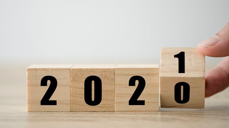 Hand flipping wooden blocks for change year 2020 to 2021 . New year and holiday concept.