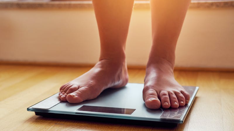 Female bare feet on weight scale