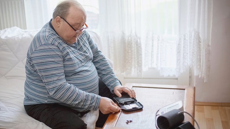 Senior man checking blood sugar levels