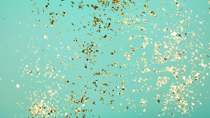 Golden flying sparkles on blue holiday background.