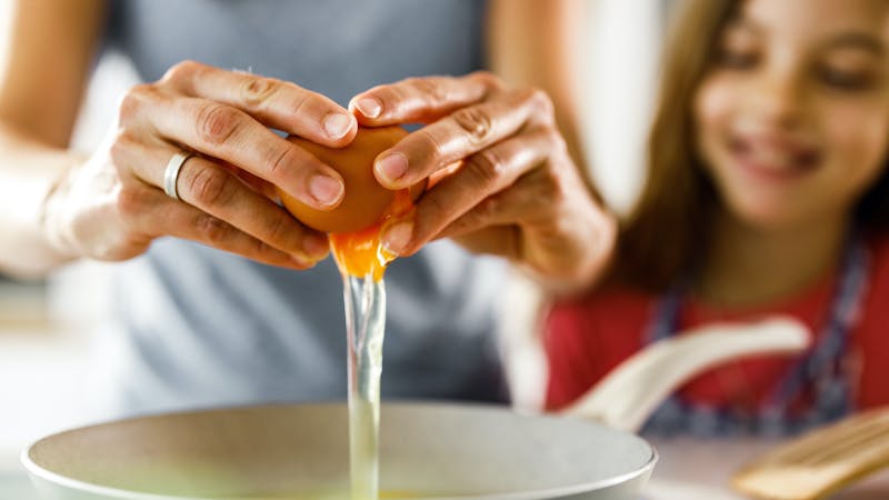 Close up of cracking an egg.