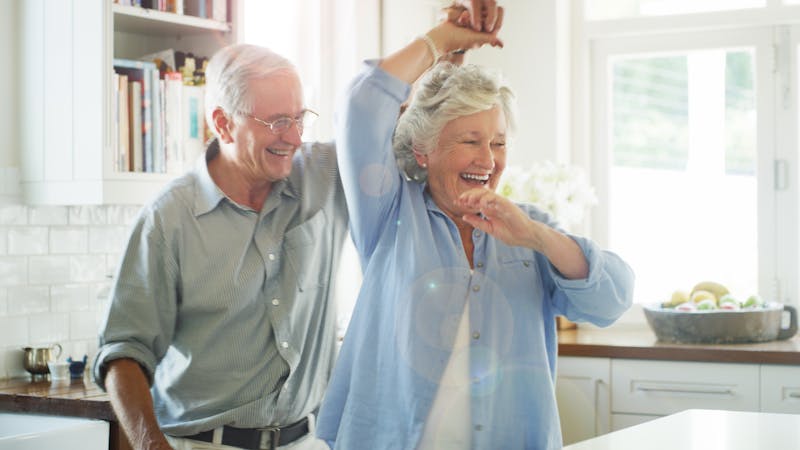 Shot of a happy senior couple dancing together at home