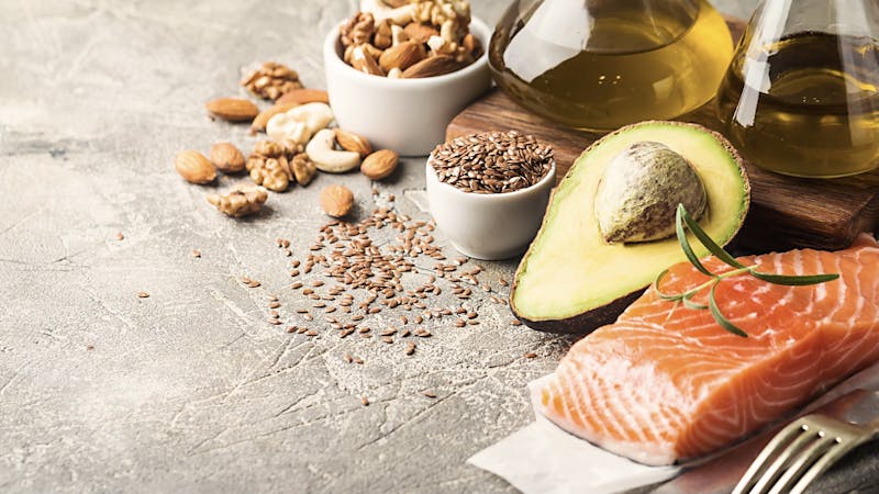 Healthy fats in nutrition – salmon, avocado, oil, nuts. Concept of healthy food