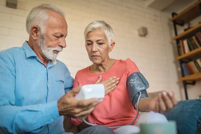 Lovely senior couple measuring blood pressure