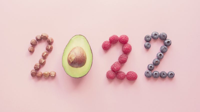 2022 made from healthy food on pink background, Happy New year, health diet resolution, goals and lifestyle