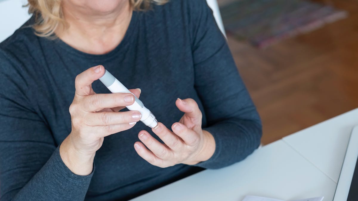 Senior Woman checking glucose level at home