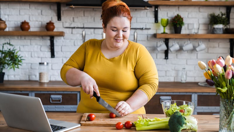 Plus size , caucasian woman learning to make salad and healthy food from social media,Social distancing, stay at home concept