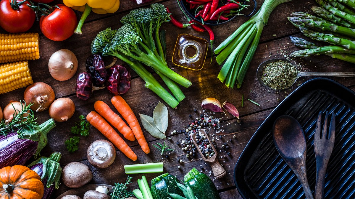 Fresh vegetables ready for cooking shot on rustic wooden table