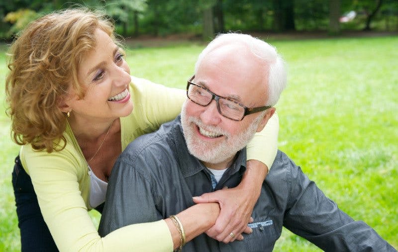 Happy older couple laughing outdoors