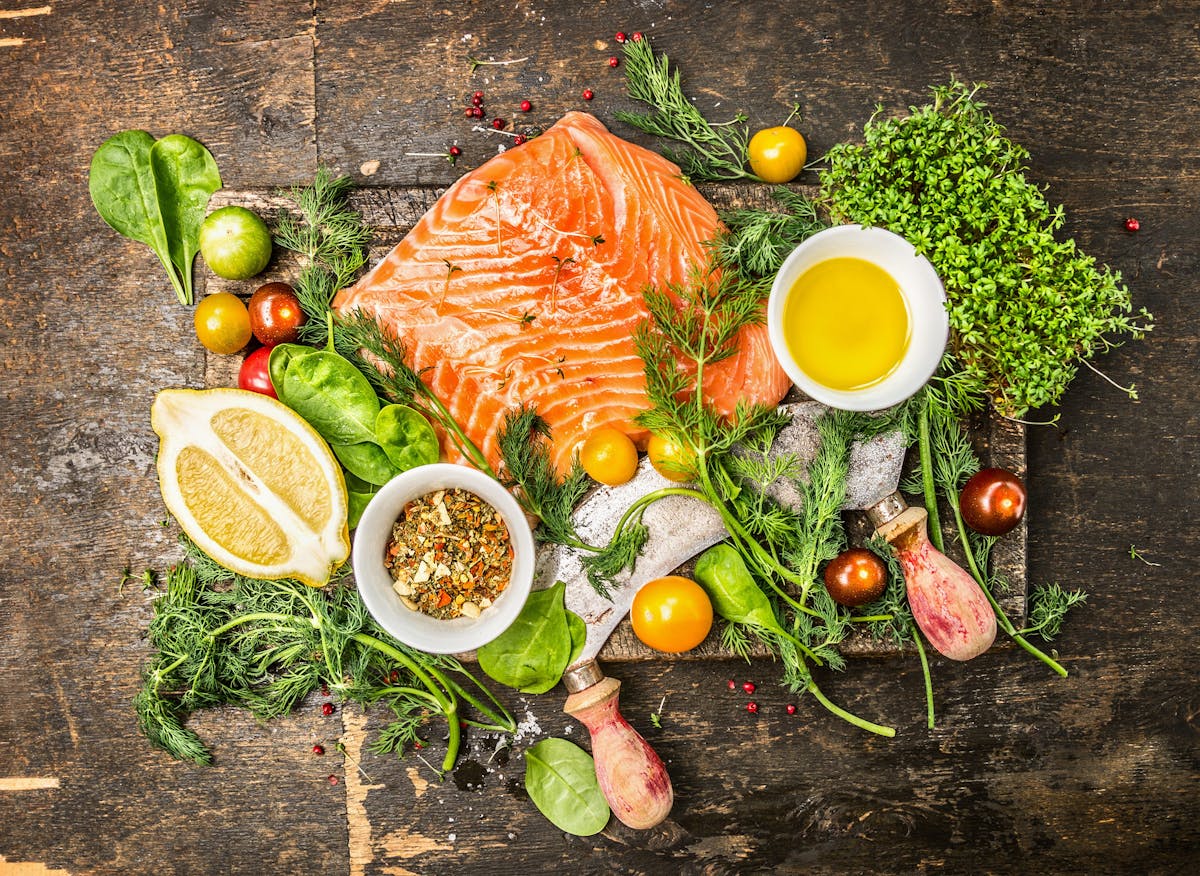 Salmon fillet with fresh healthy herbs,vegetables, oil and spices