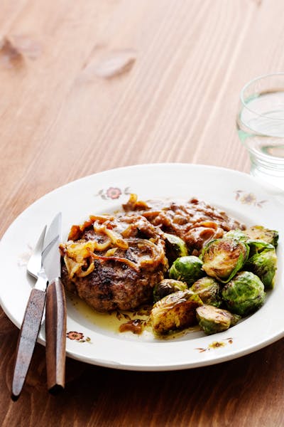 Hamburger patties with onions and Brussels sprouts<br />(Dinner)