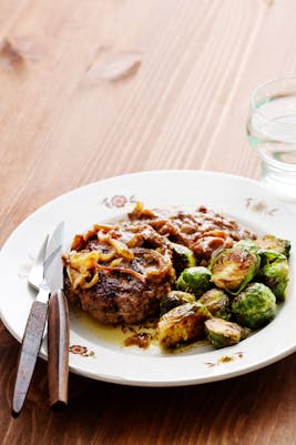 Hamburger patties with onions and Brussels sprouts