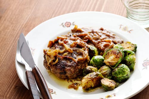 Hamburger patties with onions and Brussels sprouts