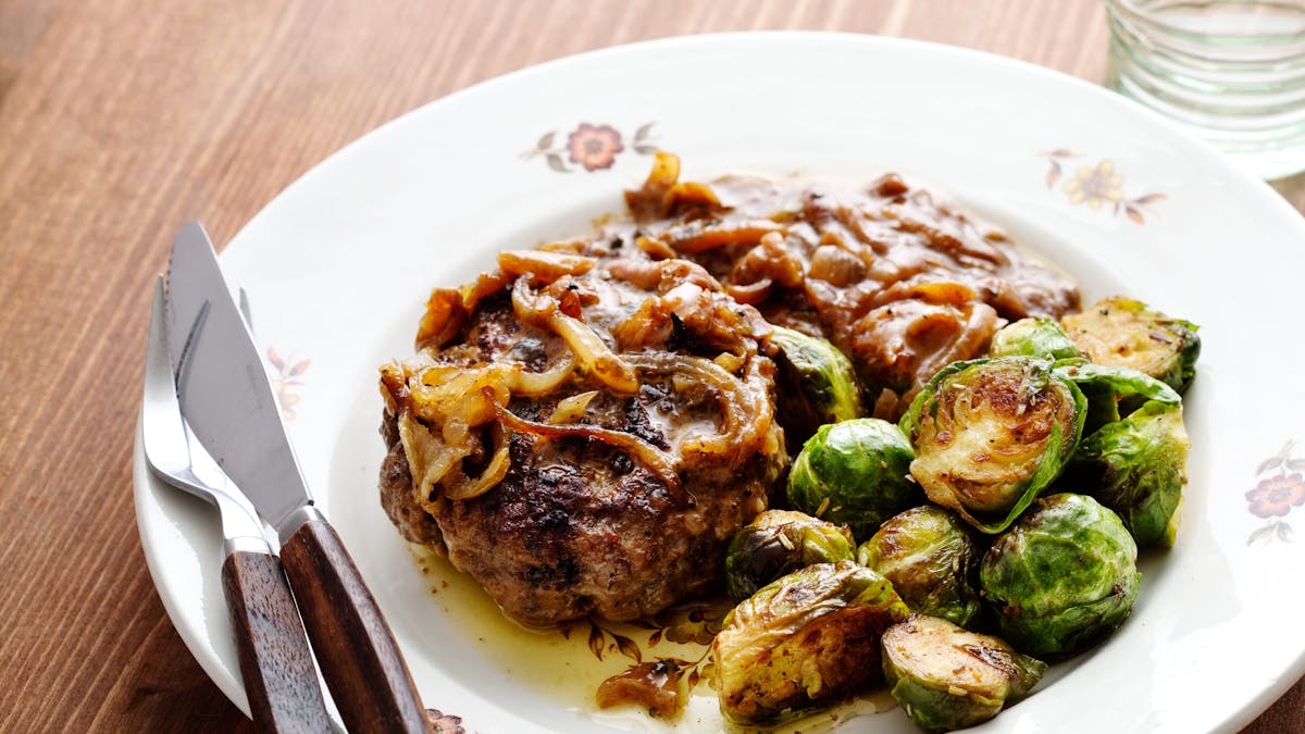 Hamburger patties with onions and Brussels sprouts