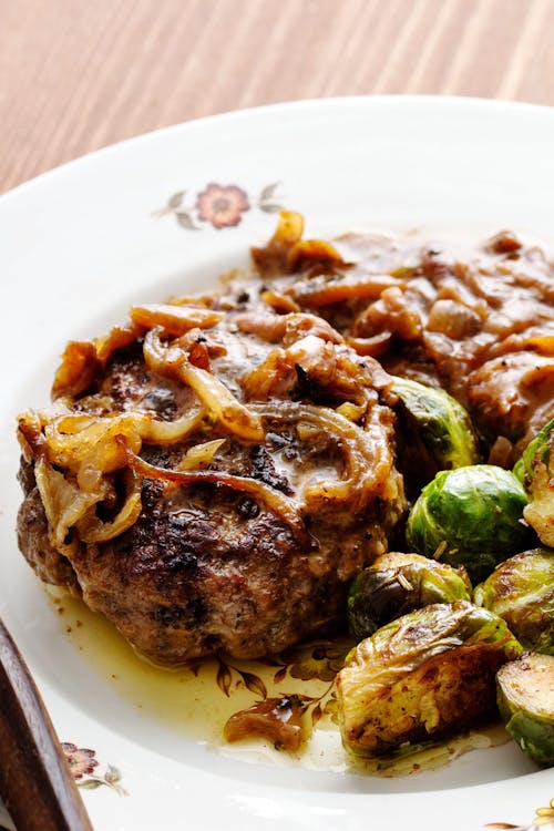 Hamburger patties with onions and Brussels sprouts