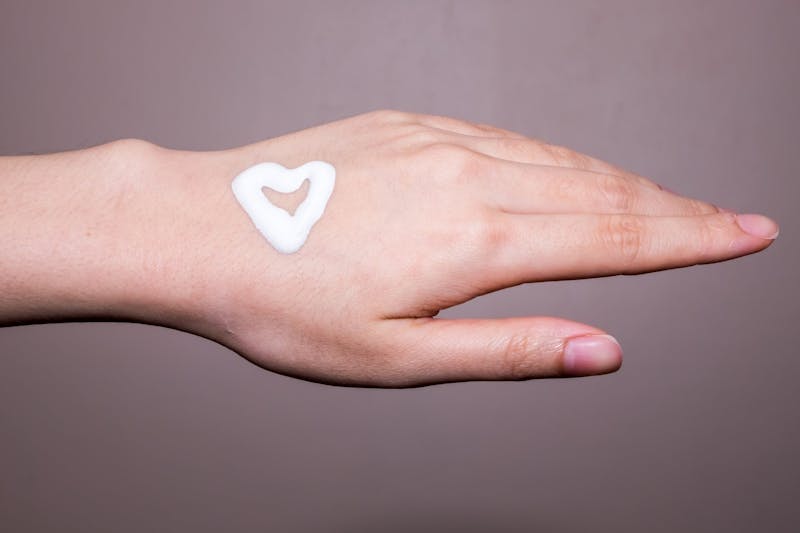 Woman applying moisturizing cream on hands