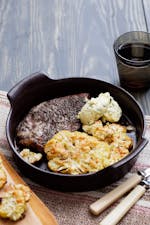 Pork chops with roasted cauliflower parmesan and herb butter