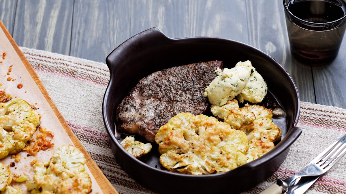 Pork chops with roasted cauliflower parmesan and herb butter