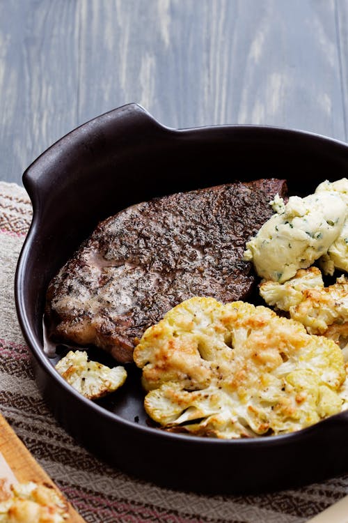 Pork chops with roasted cauliflower parmesan and herb butter