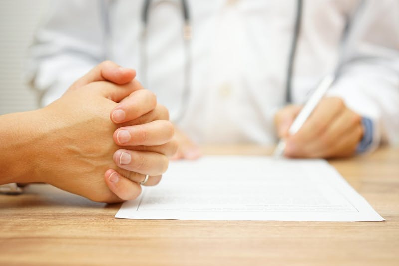 hands of Concerned Women for medical report written by doctor