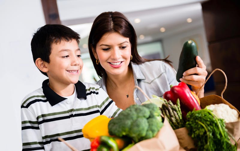 Mother and son organizing groceries