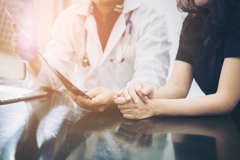 Doctor and patient consulting on a table