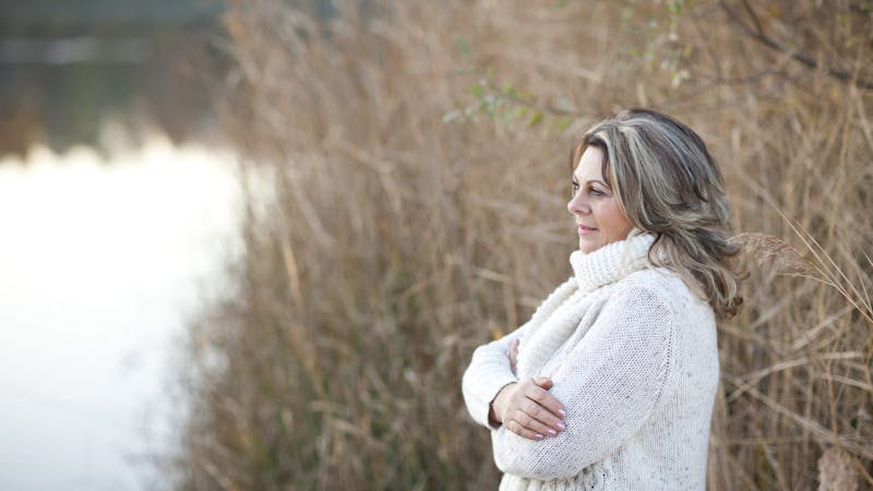 serious matured woman with crossed arms outdoor